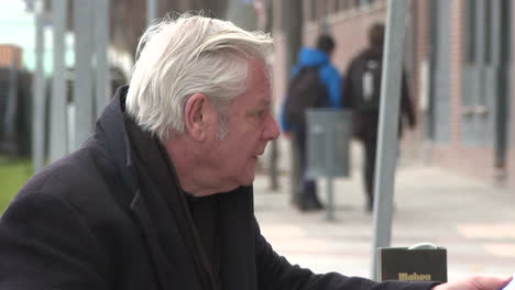 Older Man Sitting Outside a Cafe