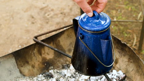 blue percolator coffee pot steams on fire - removing lid reveals spewing coffee