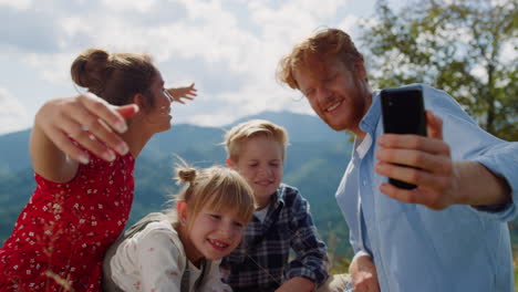 family video call nature at sunny day. parents with children using cellphone.