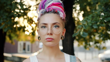 woman with colorful dreadlocks and glasses