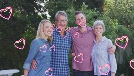 animación de los corazones sobre la feliz familia caucásica en el jardín