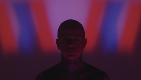 creative portrait of tattooed man with nose chain