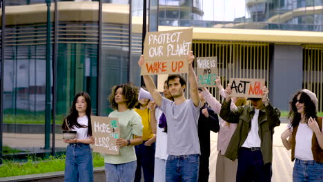 Multicultural Group Worried About The Environment Protesting Next To Business Buildings