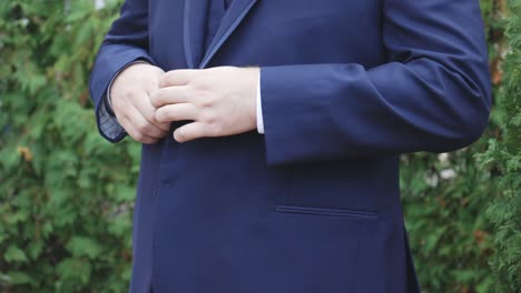 groom buttons suit before wedding