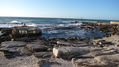 wide shot of bantry bay, south africa in late afternoon sunlight on a blue sky day at the atlantic ocean