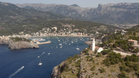 naval traffic in port de sóller bay with anchored boats and yachts