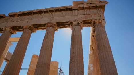 low angle of the columns of the acropolis and parthenon on the hilltop in athens greece