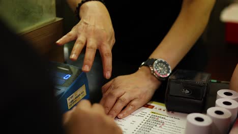 hands interacting with a menu and device