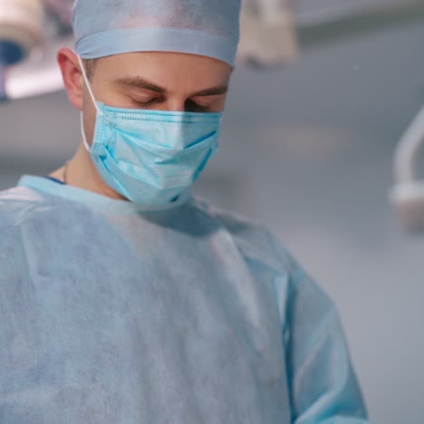 portrait of a young surgeon in blue mask. doctor is doing an operation. concentrated specialist during surgery. close-up.