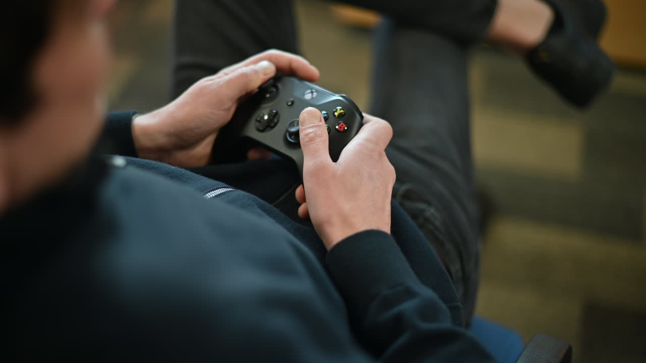 Chisinau, Moldova - March 13, 2023: Man playing video games on a Xbox console