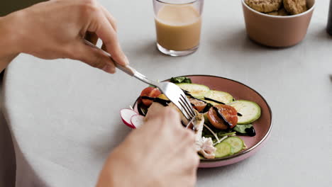 person eating a healthy meal with salad