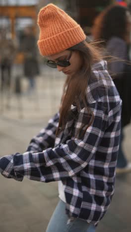 young woman in fashionable outfit on a city street