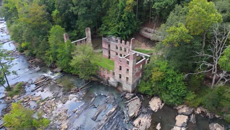 aerial shot pulling out from the new manchester mill ruins along sweetwater creek outside of atlanta