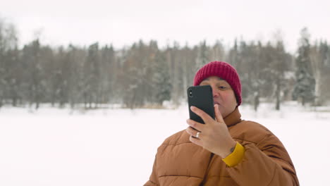 Front-View-Of-Latin-Man-In-Winter-Forest-Making-A-Selfie-1