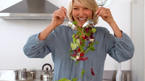 smiling woman tossing her salad