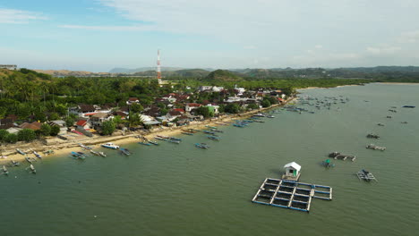 exotic township on coastline of lombok island, aerial orbit view