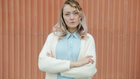 woman in light beige cardigan and pale blue shirt
