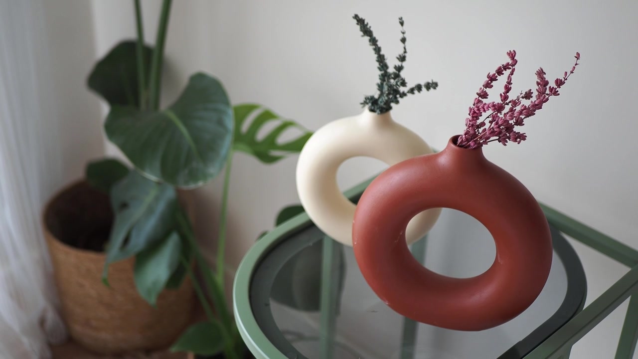 Modern Ceramic Vases with Dried Flowers on a Glass Side Table