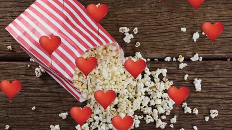 animazione di icone di cuore su una scatola di popcorn