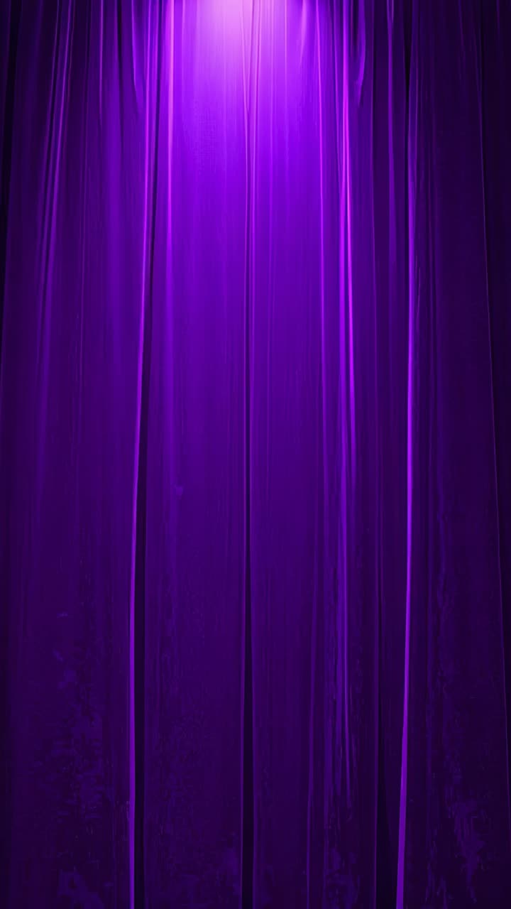 Vertical video: Turning on spotlight, casting purple wash across curtain at theater, readying stage