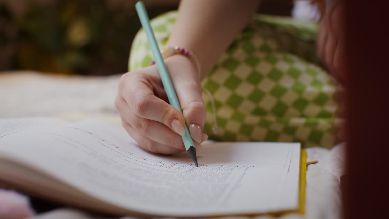 mujer escribiendo en un cuaderno en una cama