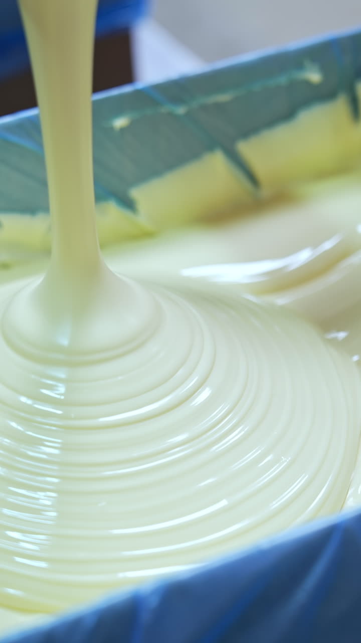 Factory cheese making in big production industry. Huge factory milk tanks for producing butter. Vertical video