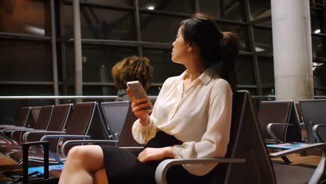 commuter using mobile phone in waiting area 4k