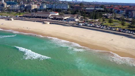 sandy beachfront on bondi beach with few people during pandemic in sydney, new south wales, australia