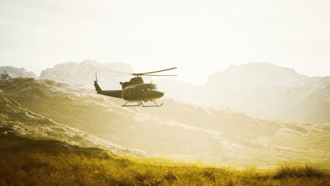 slow motion vietnam war era helicopter in mountains