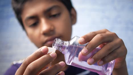 mouthwash liquid flowing into a cap , close up