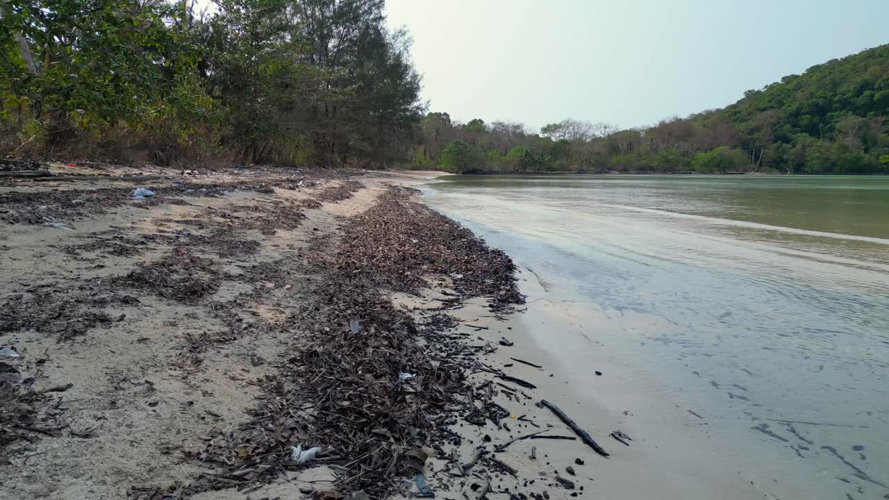 tropical vegetation meeting crystal clear water on natural beach Koh Mak island, Thailand. Great aerial view flight overflight flyover drone