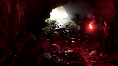 cave explorer with red flare