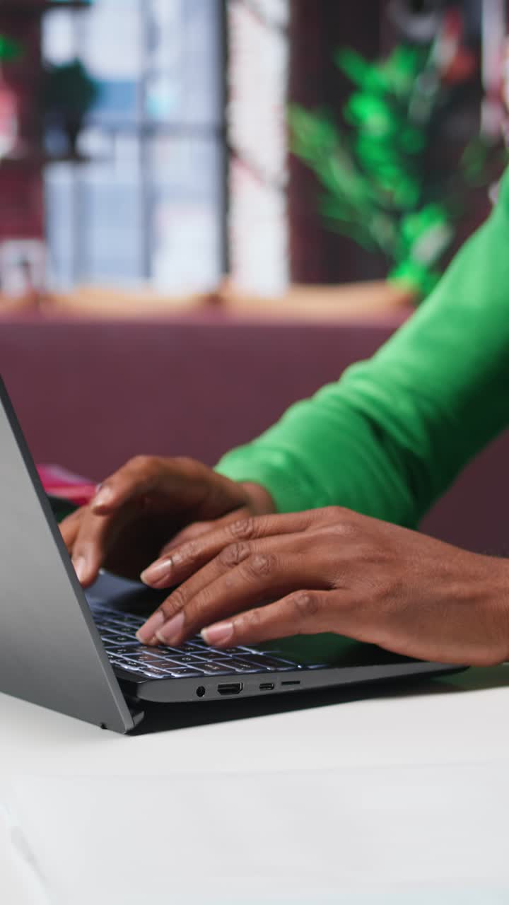 Vertical Video African american teleworker typing ideas to create a vision board on laptop