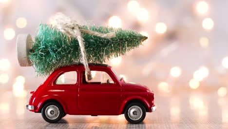 vintage red car with christmas tree on the roof