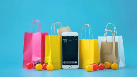 online shopping and grocery delivery - colorful shopping bags and smartphone