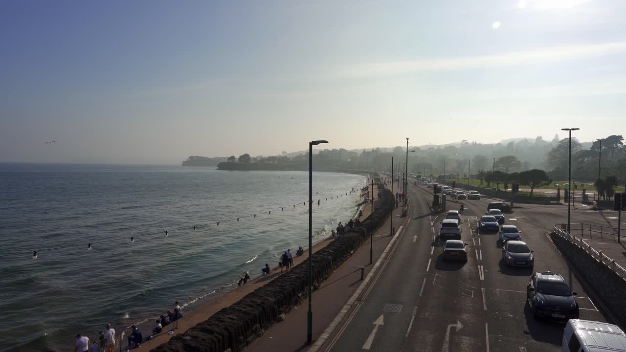 Torquay sea front promonade and road with traffic on a busy sunny day. Devon, England, UK