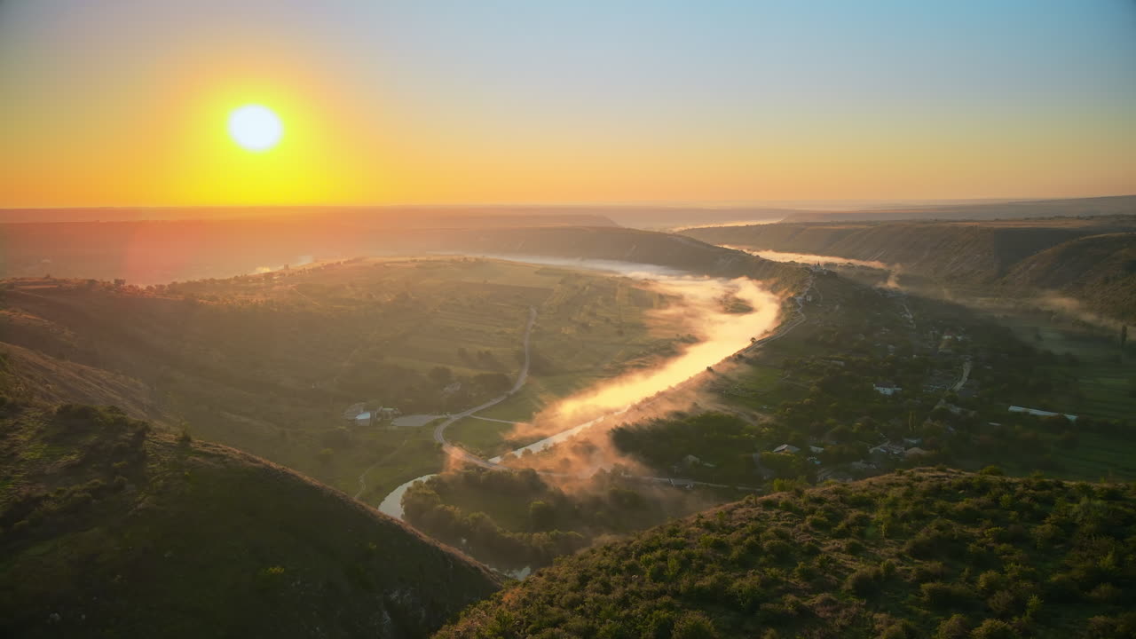 Aerial drone view of the Old Orhei at sunset. Valley with river and fog, village, monastery located on a hill in Moldova