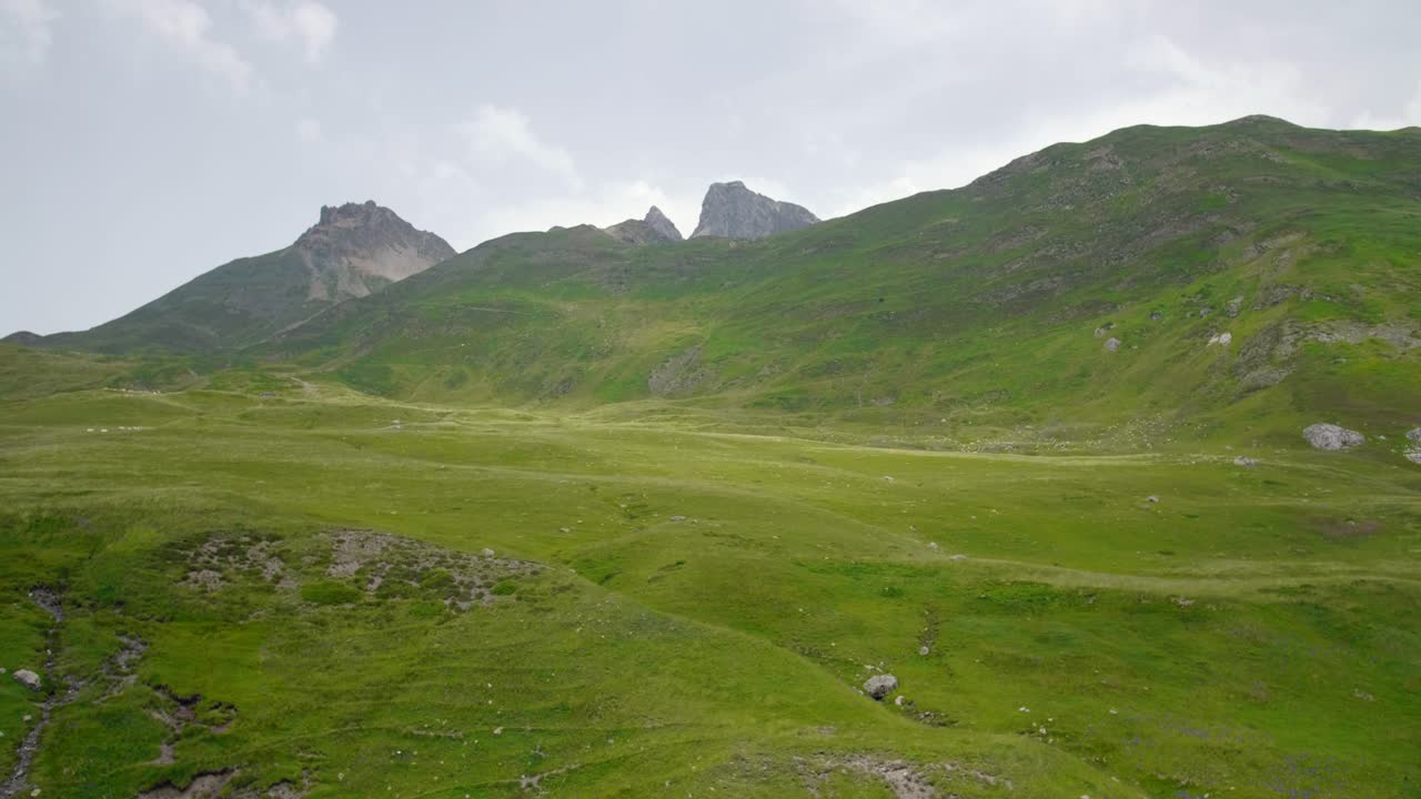 Wide angle shot of meadows and mountains festivities in the Pourtalet mountain pass in the Aragonese Pyrenees bordering the French border. Col du Pourtalet. Located in border between Spain and France.