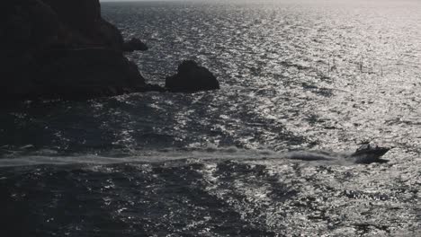 boat on the ocean with cliffs and rocks