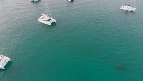 Aerial-view-of-boats-and-yachts-in-the-turquoise-waters-of-the-indian-ocean-around-La-Digue,-an-island-of-the-Seychelles