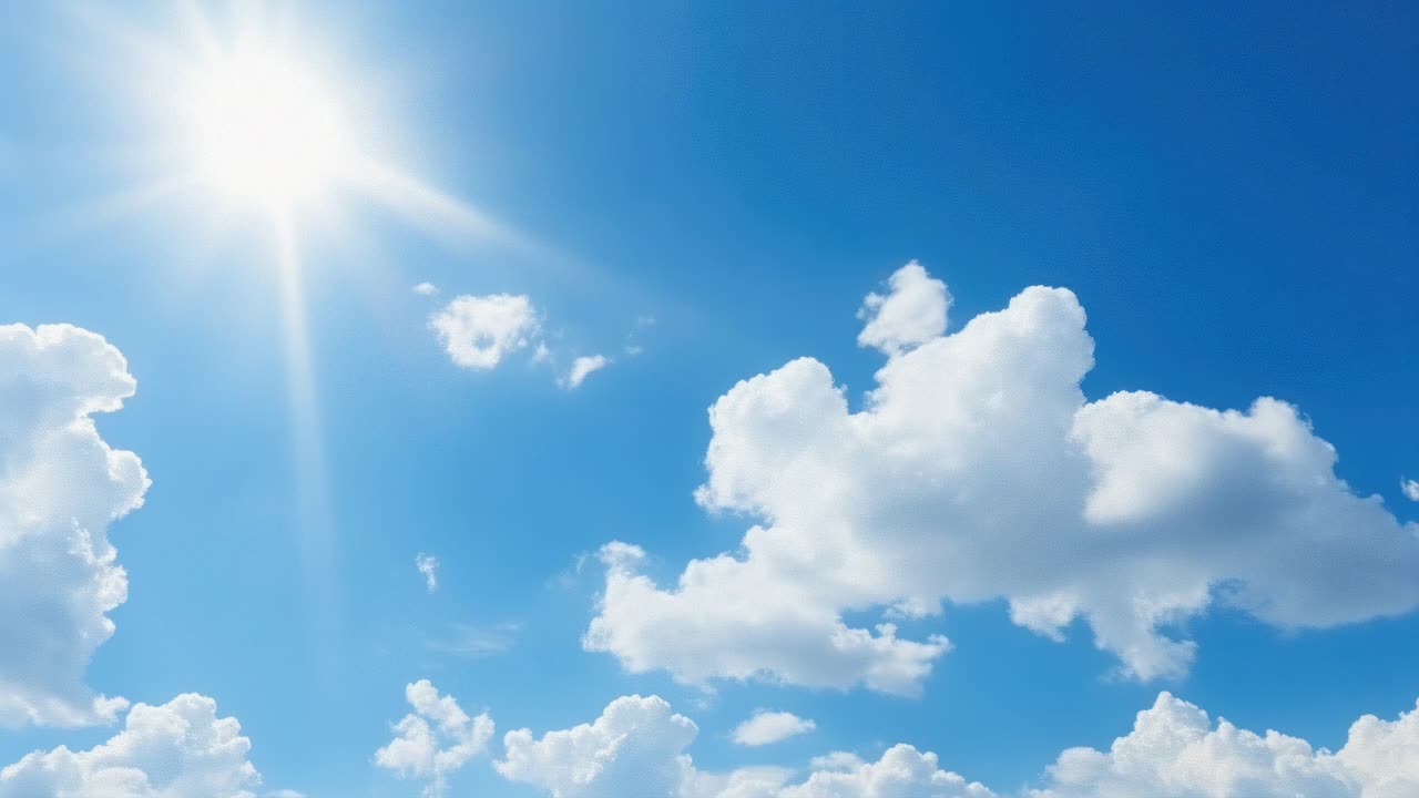 A video captures a bright blue sky with fluffy clouds and a radiant sun
