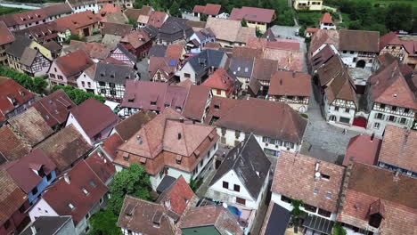 aerial shot over rooftops of half timbered houses in village of bergheim in france