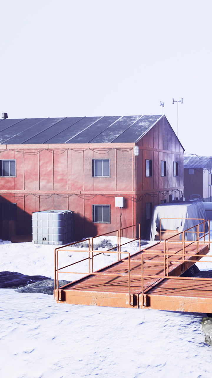 Snowy landscape with buildings and walkways near research station in winter