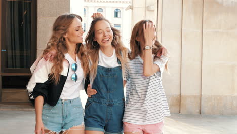 three happy friends walking together