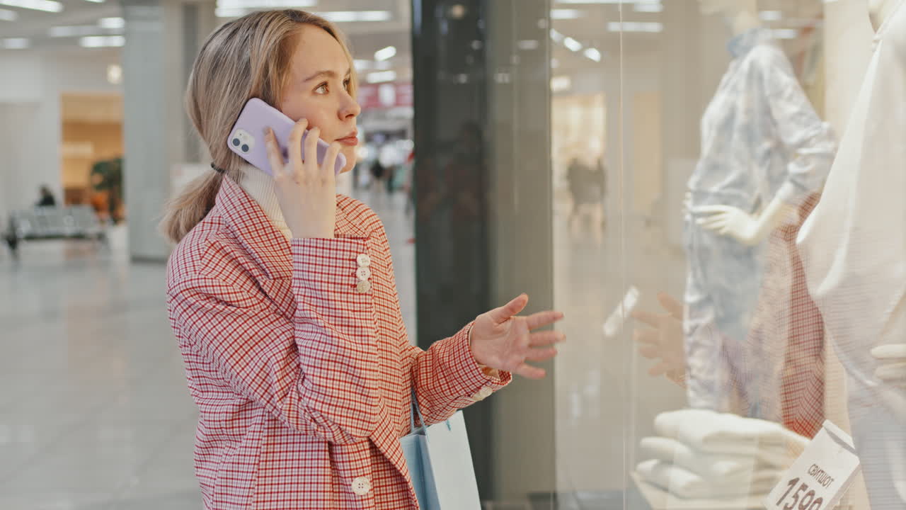 Young Stylish Woman Talking On Phone At Shopping Mall