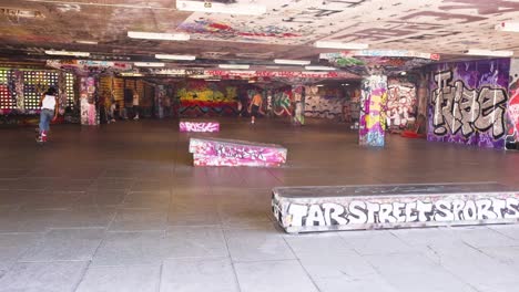 skateboarder performing tricks in urban skatepark