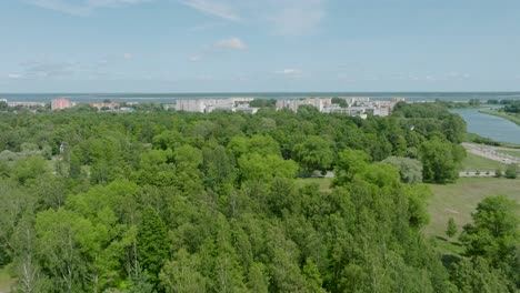 Aerial-establishing-view-of-crowded-residential-district-apartment-buildings-on-a-sunny-summer-day,-renovated-and-insulated-houses,-colorful-walls-of-the-facade,-green-trees,-drone-shot-moving-forward