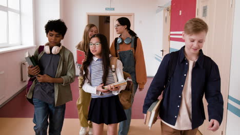 diverse group of students walking in a school hallway