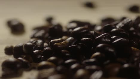 coffee beans falling onto a pile of coffee beans