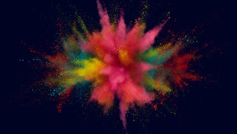 super slow motion of colored powder explosion isolated on dark background.